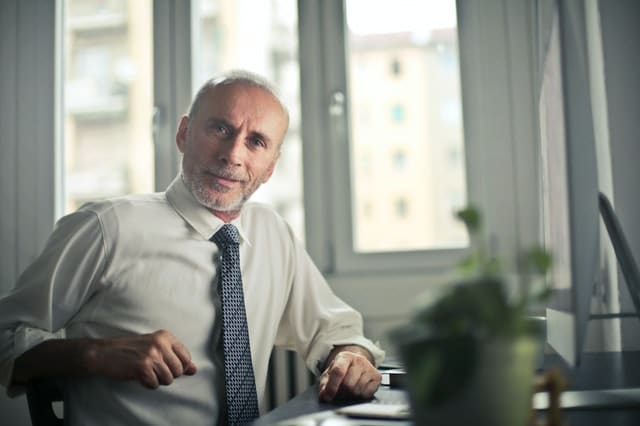 Older man with hearing loss listening