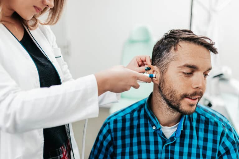 Middle age man at medical examination or checkup at audiologist's office